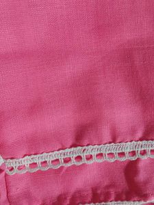 Traditional pink kurti with white embroidery.