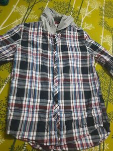 Stylish boys&#39; plaid shirt with an attached hoodie.