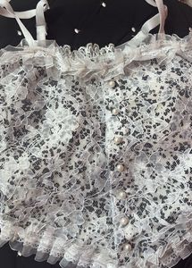 Delicate White Lace Cami with Pearl Buttons