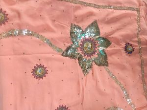Peach colour saree with blouse and peticoat