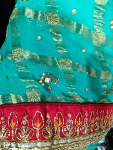 Green Colour Saree With red Lace and Kundan Work On It
