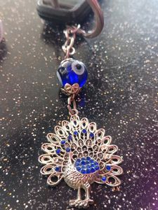 “This keychain is in the shape of a peacock, it i