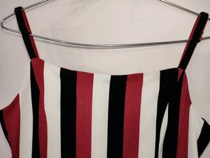 fitted bodice and down to elongated flared Pants