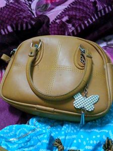 Tan Handbag with Butterfly Charm
