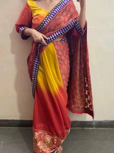 YELLOW ORANGE SHIFFON AND HEAVY EMBROIDERY SAREE