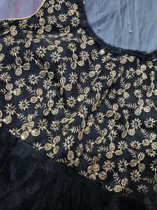 black paplum blouse and grey skirt