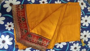 A Light Organe Saree With Red Broad Embroidery