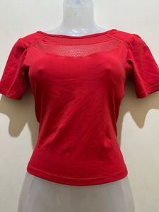 top features a V-shaped strap design at the back