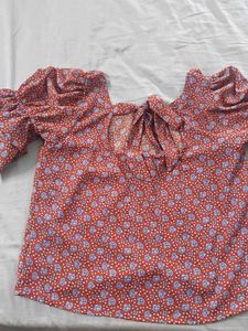 Red top with floral blue pattern