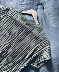 top or sweater in a muted sage green