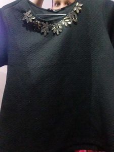 Textured Black Top with Leaf Embellishments