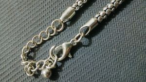 A Black Necklace along With White One
