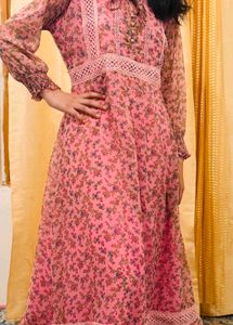 A pink floral gown with white lace trim