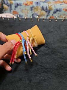 Set Of Four Guruji Thread Bracelets With Cushion