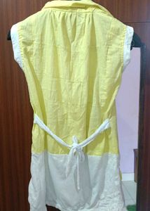 A Yellow Long Sleveless Top With 2 Pockets