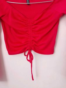 branded red long sleeves crop top.