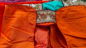 Orange Saree With Turquoise And GoldenBorder