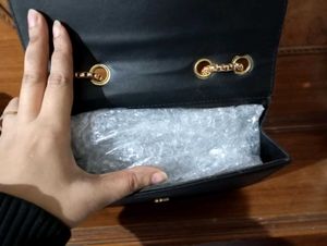 spacious black sling bag