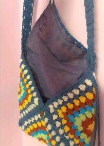 beautiful adjustable crochet sling.