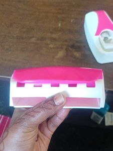 Toothpaste dispenser with toothbrush holder
