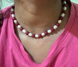 it’s a chain . it’s white and maroon mixed col
