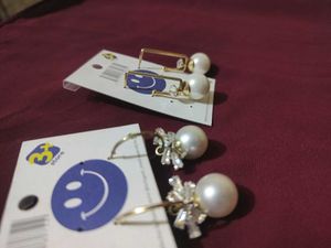 2 pair of gold plated pearl earrings with a stone