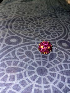Vibrant purple rose cluster ring with golden Stone