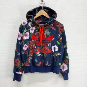 This is an Adidas x Rita Ora navy floral pullover