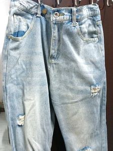 A ripped blue denim jeans