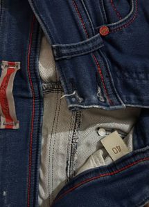 Blue jeans with beautiful red threadwork