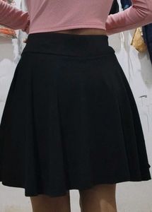 a black skirt with attached shorts inside