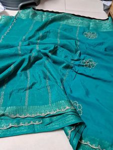 Elegant Teal Saree with Floral Detail