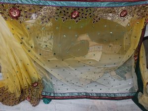 Yellow Net Saree With Sleeveless green Blouse