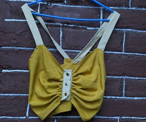 mustard yellow crop top .