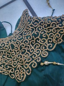 Luxurious Silk Dark Green Gown With Golden Stone