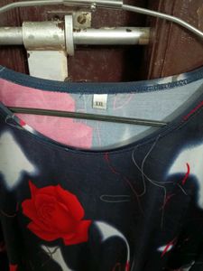 smart black top with red flowers on it