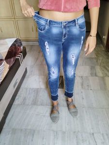 Navy Blue Ripped Jeans With A Design On Bottom