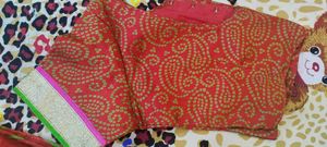 Bright red Gujarati leheriyu saree with pink and green border lace with blouse