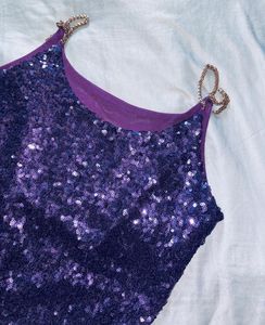 The fabric is covered with small, shiny sequins th