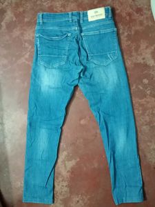 Distressed Denim Jeans With Scratches