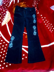 Black Coloured Bootcut Jean With Embroidery On It.