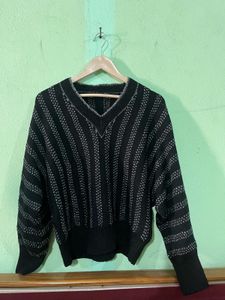 black V-neck sweater with wide, dolman-style sleev