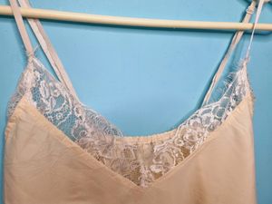 Cream Cami Top With Net Design On Neck.