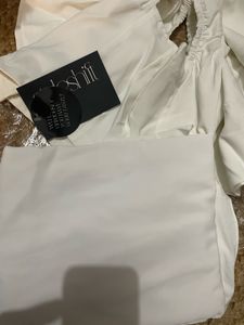 Pleated asymmetric drape skirt.