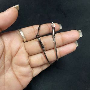 large silver-toned hoop earrings.