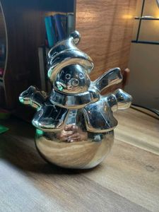 A Shiny Silver Snowman Figurine With Top Hat
