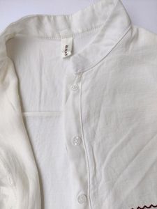 White shirt with red scallop detailing