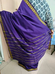 Purple coloured artificial silk saree with 1.5 inch ethnic design golden border