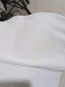 white ribbed cropped top with a charm