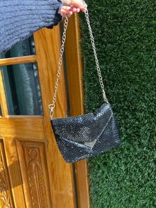 Black metal mesh sling bag